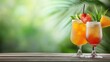 © Nisit - Refreshing summer cocktails garnished with tropical fruits on a wooden table against a blurred background