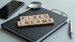 © Rizvan - Text reading FIXED INCOME displayed on a wooden block atop a notebook, showcasing a business concept.