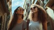 © elena - Two friends walking and having fun on a city trip in barcelona