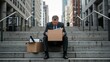 © Qbertstudio - Middle aged Caucasian businessman sits on city stairs holding cardboard box Reflects on career transition and emotional struggle