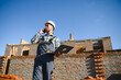© Serhii - Architect or engineer on construction site with laptop monitoring construction process