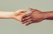 © Yevhen - Woman and man holding hands together. Woman and african woman hand. Giving a helping hand to another