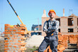 © Serhii - Construction worker in uniform and safety equipment have job on building