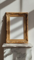 Fototapete - An ornate golden frame stands against a white wall, beautifully reflecting light and casting delicate shadows on an exquisite marble surface. The serene atmosphere invites imagination