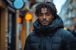 © Alina - African man in black puffer jacket in winter time