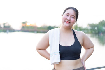 cheerful attractive young overweight woman weight loss concept, asian smiling woman in sports bra, e