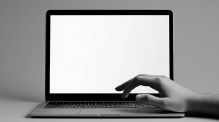 Hand interacting with laptop showing blank white screen on grey background. Close-up of a hand using a laptop with a blank white screen, perfect for mockups or showcasing content