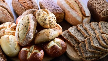 Fototapete - Assorted bakery products including loaves of bread and rolls