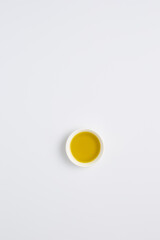 Aufkleber - Minimalist Aerial View of a Single Bowl with Yellow Liquid on White Background