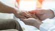 © Chinnapong - Arthritis or parkinson disease elderly patient, old aged senior woman holding geriatric doctor, cargiving nurse or family assistant's hand in hospice home for medical health care or mental therapy