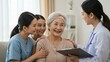 © Qbertstudio - East Asian elderly woman enjoys conversation with healthcare professional and young women in nursing home Highlights caregiving and compassion