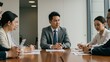 © Qbertstudio - Asian businessman leads a corporate meeting with diverse professionals in a modern conference room Focus on business collaboration