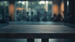 © Irina - Empty table top with a blurred gym interior