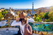 © moofushi - A tourist woman enjoys a sightseeing trip of the famous Park Güell in Barcelona, Spain, on a sunny day