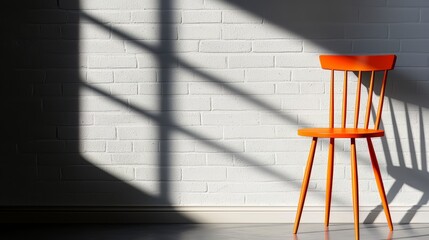 Aufkleber - Chair is sitting in front of a white wall. The chair is orange and is casting a shadow on the wall