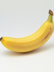 Leinwandbilder - Minimalist display of a single ripe banana on a soft pastel background under natural lighting
