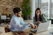 © Jovan - Team Collaboration in Modern Office Space With Laptop and Happy Coworkers