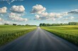 © YouraPechkin - Expansive rural road stretches through green fields under a bright sky with fluffy clouds