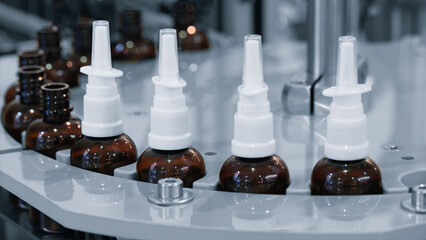 Poster - medicine bottles, each with a white cap, are lined up on a manufacturing packaging line. The bottles are brown and white and they appear to be in a row.