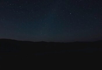 Wall Mural - Shimmering stars twinkling over a dark desert landscape, galaxy, cosmic dust