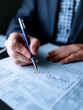 © CreativeIMGIdeas - Analyzing Market Trends: A focused professional meticulously examines a financial report with a pen, scrutinizing charts and data. This image encapsulates the essence of diligent analysis.