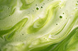 © agungai - frothy matcha latte with its signature vibrant green color and delicate swirling foam patterns, a macro and full-frame texture shot, close-up texture, top view