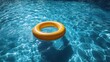 © Sang - A bright yellow inflatable ring floats on rippled turquoise pool water, ideal for summer holidays and resort fun.