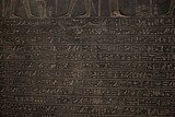 ancient Egyptian carvings and hieroglyphs on sand stones at the Grand Egyptian Museum in Cairo, Egypt