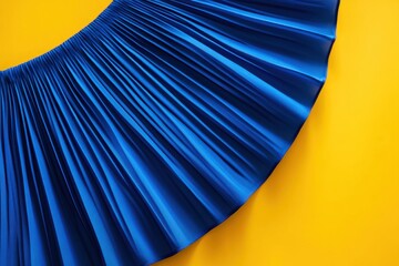 Poster - Vibrant blue fabric draped against a bright yellow background creates a striking visual contrast in texture and color