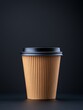 © Theodore Hart - A disposable coffee cup with a black lid against a dark background