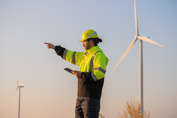 Aufkleber - Engineer man working with tablet at windmill farm Generating electricity clean energy. Wind turbine farm generator by alternative green energy.