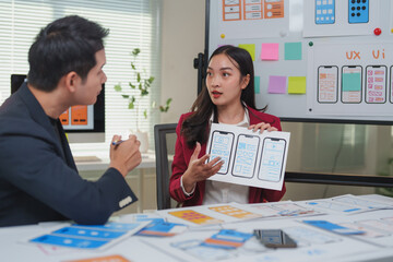 Wall Mural - ux ui designers discussing mobile app interface wireframe design