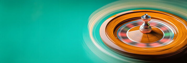 Wall Mural - motion blur of a roulette wheel spinning at a casino wide banner - green background