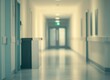 © El Media - Walking Down Hospital Corridor with Doors and Equipment for Healthcare