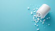 ©  Shomixer - A collection of various white pills scattered around a pill bottle laid on a vibrant blue surface, emphasizing health and wellness themes in modern life.
