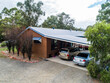 © Austockphoto - Family home with two cars parked in carport