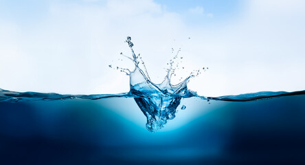 Leinwandbilder - A dynamic water splash erupts from the surface, creating a crown shape against a gradient blue sky fading to white. The water transitions from deep to light blue.