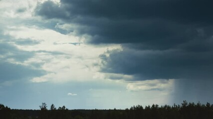 Wall Mural - Time Lapse Dramatic Sky With Heavy Rain Clouds Above Forest. Time-lapse Colorful Cloudy Dark Blue Sky Fluffy Clouds. Rain Above Forest Landscape. Rain Cloud Formation Timelapse. Dark Sky. Clear Sky