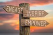 © Nopadon - Employee engagement fosters loyalty and deeper workplace involvement concept. Wooden signpost with motivational words against a sunset background.