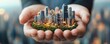 © Nattapat - Hands enveloping a tiny urban landscape, conveying expertise in real estate opportunities, ultrarealistic, softfocus background