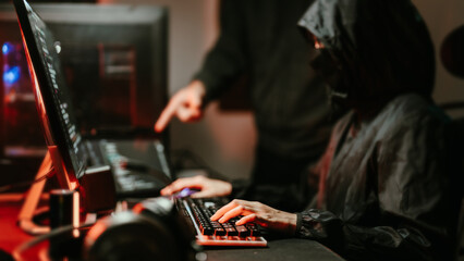 Wall Mural - hooded hacker coding destroy online data system with virus ransomware in server..