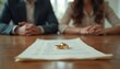 © miss irine - Close up shot of wedding rings lying on divorce papers with blurred couple background. Marital property division. Concept of legal separation, asset split, broken relationship.