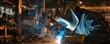 © kirania - Welder skillfully creates sparks in an industrial setting