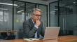 © StockWorld - Thoughtful Businessman with Laptop in Modern Office | Executive Strategy, Professional Success, Leadership Inspiration