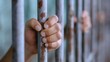© Moopingz - Hands grasping rusty prison bars, conveying a sense of confinement and despair.