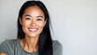 © Nataliya - Cheerful young Asian woman smiling in casual outfit