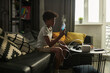 © pressmaster - Adorable child with inhalation mask in hand sitting on couch in front of table with electric nebulizer before medical treatment