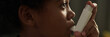 © pressmaster - Header of face of youthful boy with asthma attack pumping inhaler in mouth while standing in front of camera