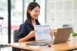 © Kritdanai - Asian Woman Presenting Business Data Online