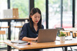 © Kritdanai - Focused Young Woman Working on Laptop